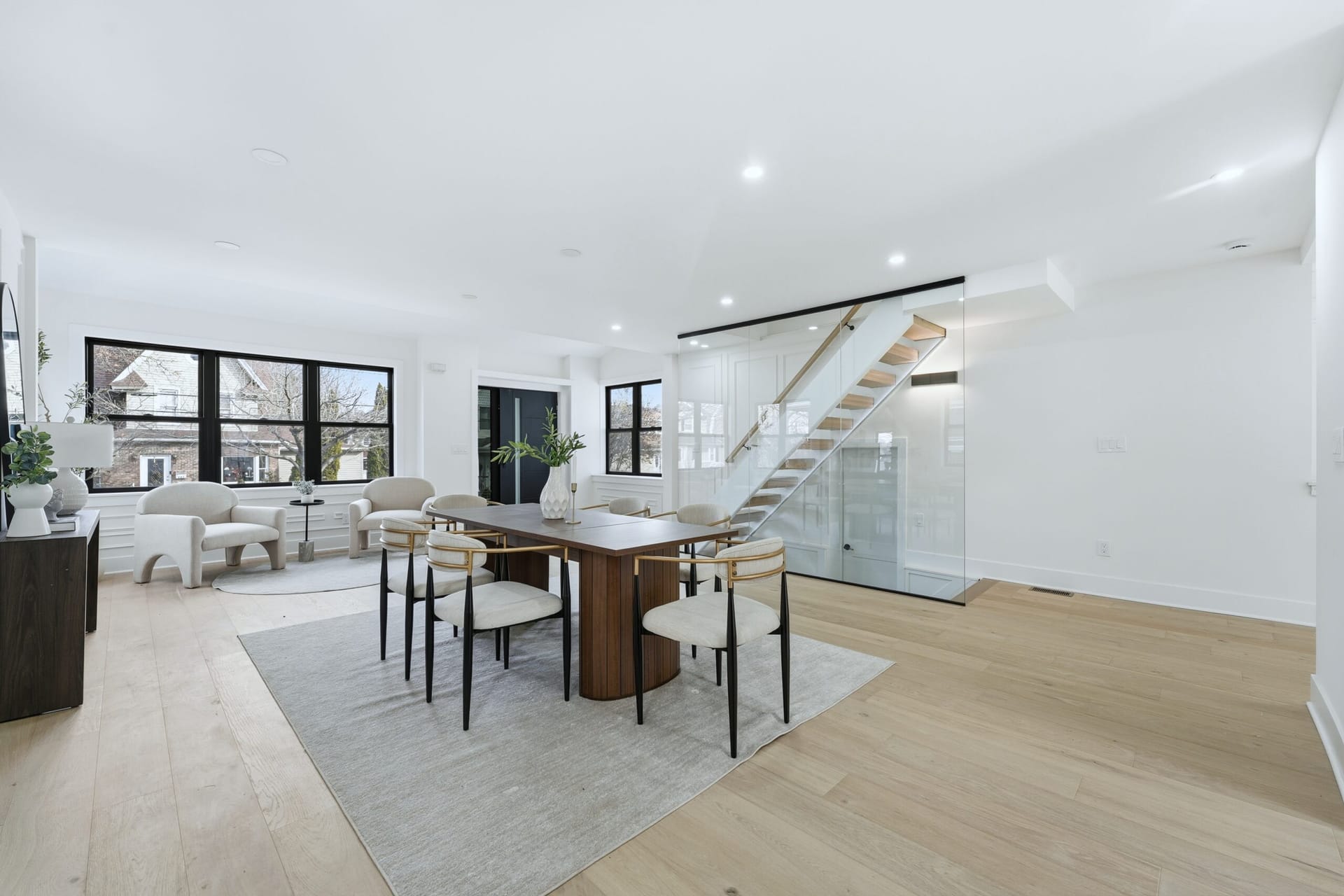 Bedroom with white oak floors and black-framed windows in the 820 Elm Avenue renovation