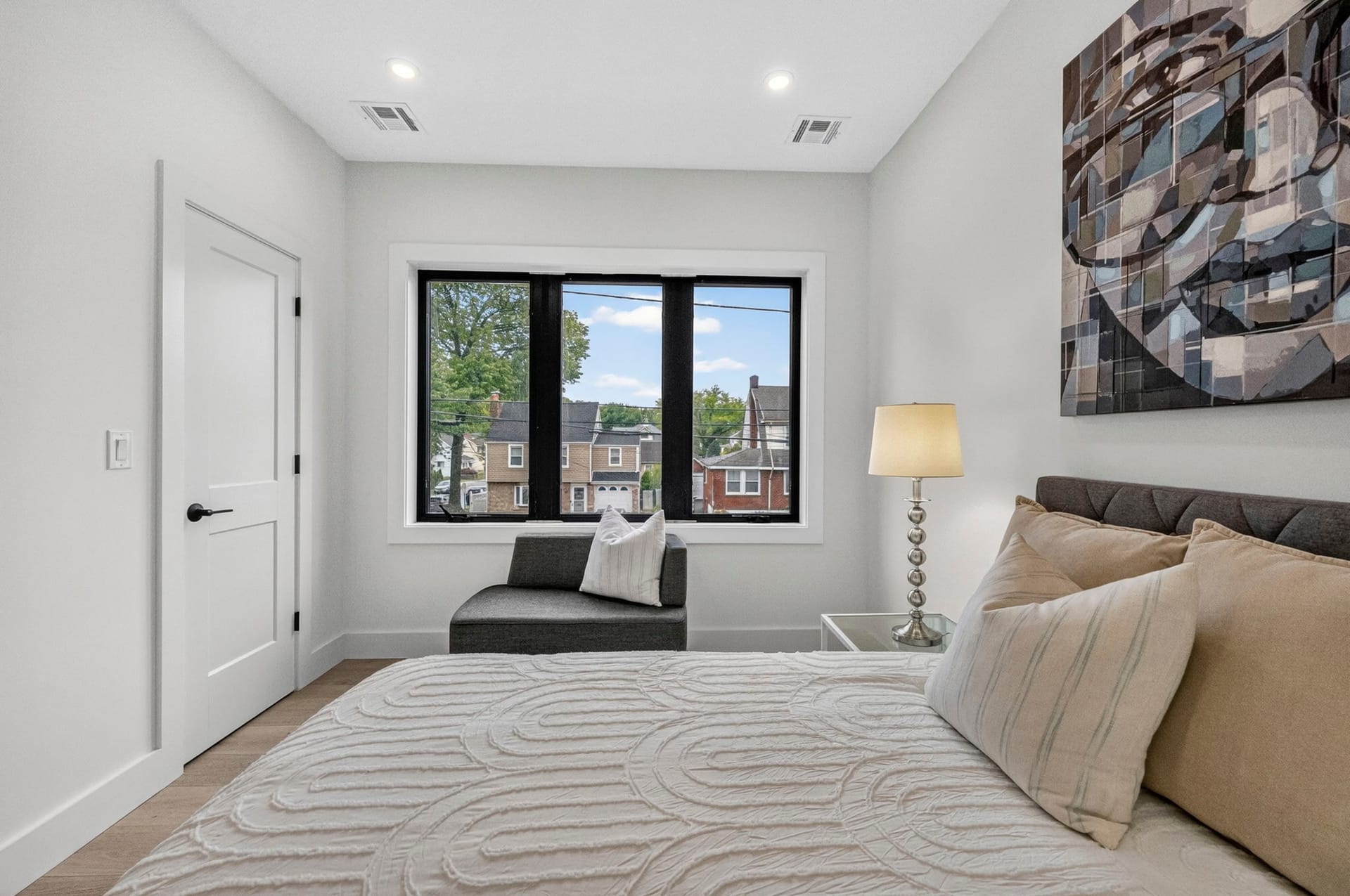 Bedroom with framed abstract art and a window seat