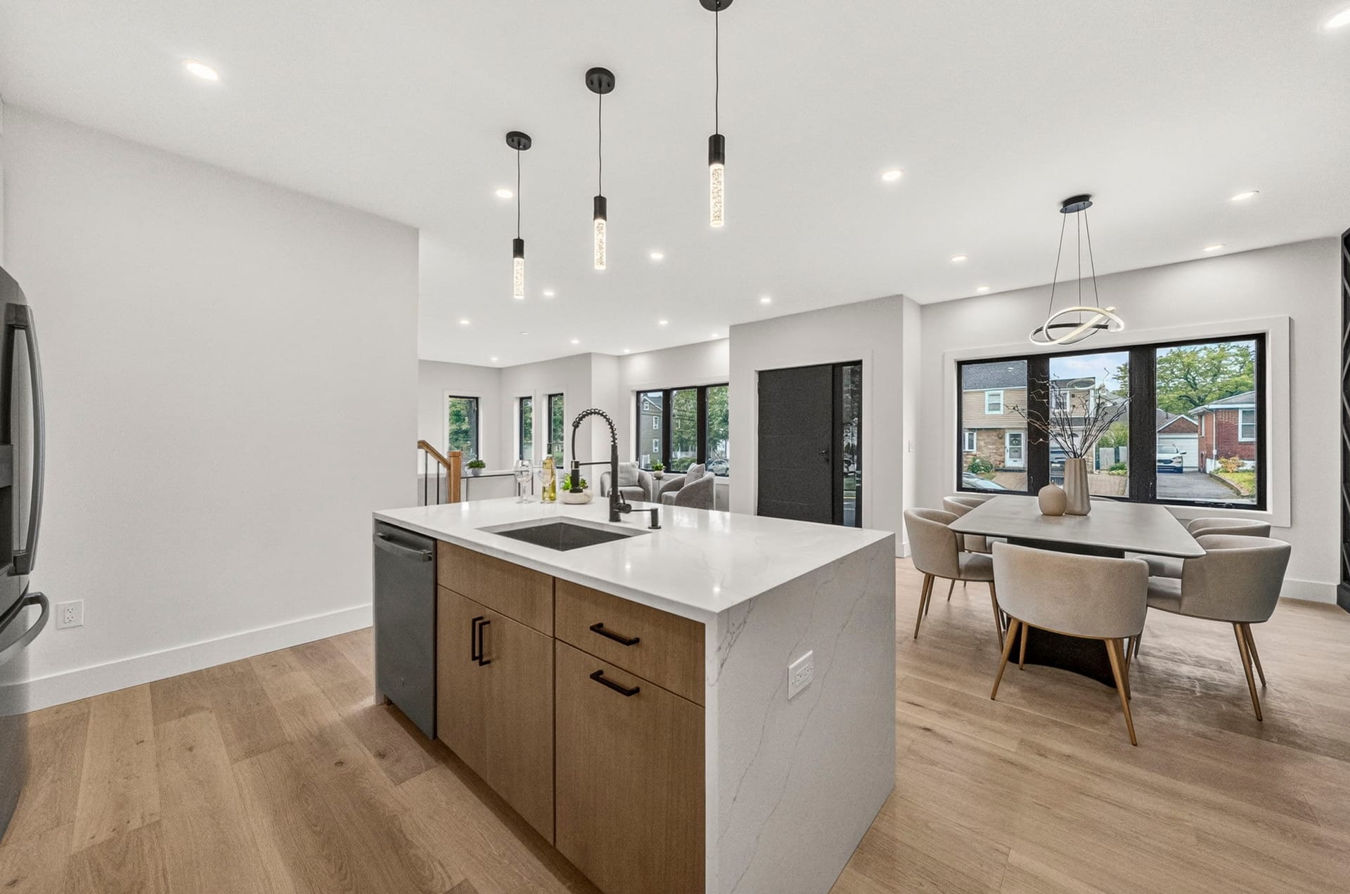 Open kitchen and dining layout with wood-tone cabinetry